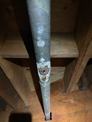 Close-up of mineral buildup and corrosion on aging pipe, Tampa FL
