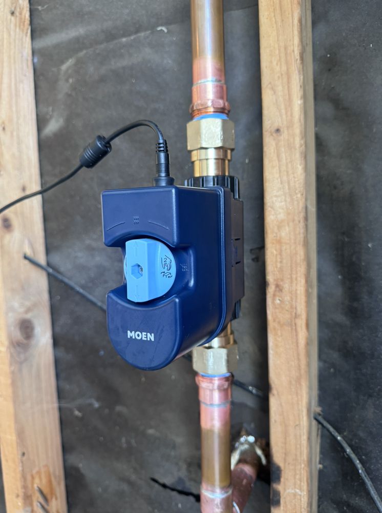 Smart automatic water shutoff valve installed indoors on copper pipe, Tampa FL